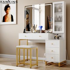 a white vanity with two stools in front of it and a mirror on the wall