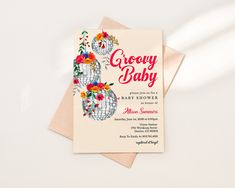 a baby shower is shown with flowers on the front and back of it's card