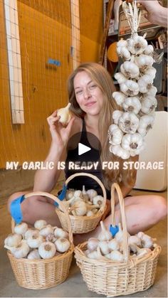 a woman sitting on the floor with baskets full of mushrooms in front of her and text that reads, my garlic is ready for storage