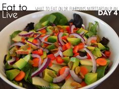 a white bowl filled with vegetables on top of a wooden table