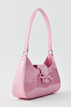 Kimchi Blue Blair bow bag in high-shine faux leather. Slim shoulder bag with a femme feel and bow accent. Features Kimchi Blue Blair bow bag Luxe patent bag Structured silhouette Slim size that fits the essentials Bow-topped closure Fixed shoulder strap UO exclusive Content + Care 100% PU Hand wash Imported | Kimchi Blue Blair Bow Bag in Pink, Women's at Urban Outfitters Sweetly Bag, Cute Pink Shoulder Bag, Spring Bags 2024, Blue Designer Bag, Pink Baguette Bag, Pink Kawaii Shoulder Bag For Everyday, 90s Bags, Feminine Pink Bag With Bow, Ceramic Bag