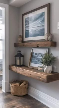 some shelves with pictures and plants on them in the corner of a room next to a door