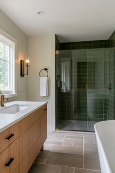 a large bathroom with a walk in shower next to a bathtub and sink area