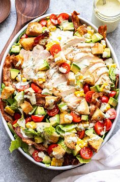 chicken blt salad in a bowl with dressing on the side and text overlay