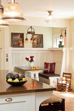 a bowl of fruit sitting on top of a kitchen counter