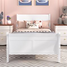 a bedroom with pink walls, white furniture and two teddy bears on the nightstands