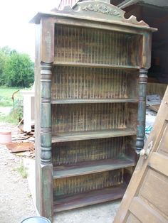 an old wooden bookcase sitting next to a door