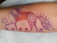 a woman's arm with a tattoo on it that has an image of a horse