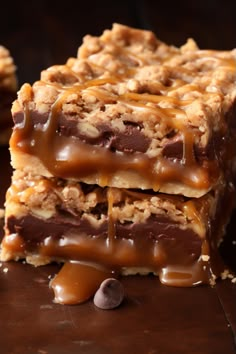 three pieces of chocolate caramel granola bars stacked on top of each other