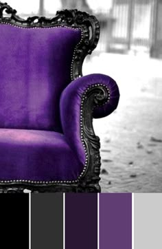 a purple chair sitting on top of a floor next to a black and white wall