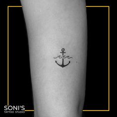 a small anchor tattoo on the leg