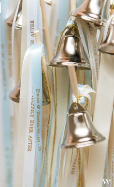 several bells hanging from ribbons in a room