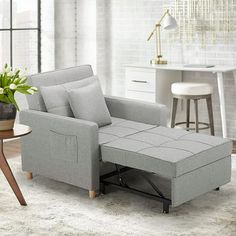 a living room scene with focus on the recliner and footstool in the foreground