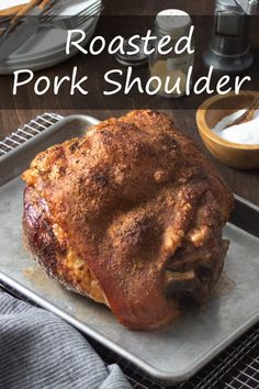 roasted pork shoulder on a baking sheet with text overlay that reads roasted pork shoulder