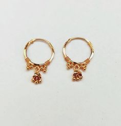 22k solid gold hoops earring with tiny gold balls and with carving touch and dangling design EARRING SPECIFICATION: Size inside: 12mm Size outside: 14mm Metal type: Gold Metal purity: 22 k solid gold Weight: 1.80 gram Location : Earlobe All jewellery is made with love and care in my studio. Shipping will be processed within 1-2 working days by express shipping and order will be delivered to you within 7-8 working days. Customers satisfaction is our utmost priority, feel free to have any query an Ring Type Earrings Gold, Gold Earrings For Kids, Earrings For Kids, Indoor Water Garden, Gold Pearl Jewelry, Antique Necklaces Design