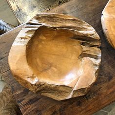 a wooden bowl sitting on top of a table