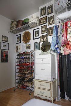 a bedroom with lots of shoes and pictures on the wall above it, along with an old dresser