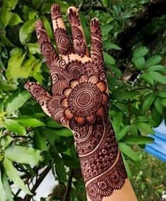 the hand is decorated with henna on it