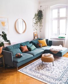 a living room filled with furniture next to a window