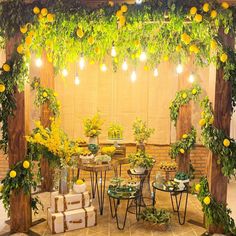 an outdoor event with lemons and greenery on the walls, tables and chairs