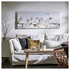 a white couch sitting next to a wooden table