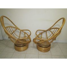 two rattan chairs sitting next to each other on a tile floor in front of a white wall