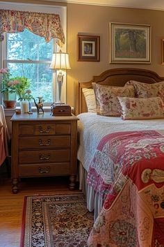 a bed sitting in a bedroom next to a window covered in pillows and blankets on top of a rug