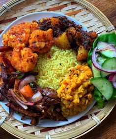 a plate with rice, meat and vegetables on it