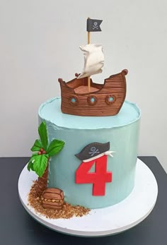 a birthday cake with a pirate ship on the front and number four on the back