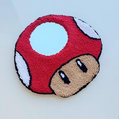 a close up of a nintendo mushroom rug on a table