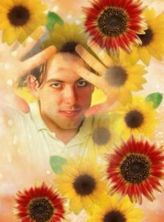 a man is surrounded by sunflowers with his hands