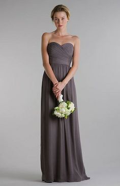 a woman in a strapless dress holding a bouquet