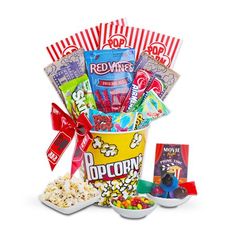 the popcorn bucket is filled with snacks, candy and candies to make it look like they're going on a movie