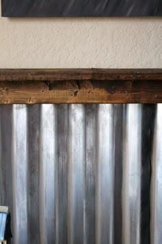 an old window with metal bars in front of it and a sign on the wall