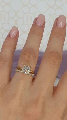 a woman's hand with a ring on it and a diamond in the middle