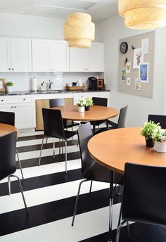 a kitchen filled with black and white striped flooring next to a dining room table