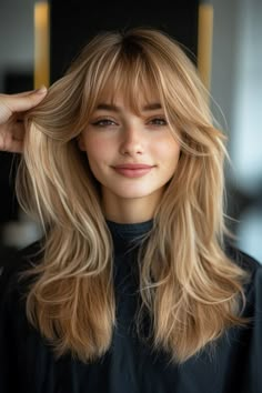 Click for More ➡️ | Save for Later ❤️  This honey blonde shag cut is all about volume and texture. The layers are tousled for a carefree, messy look, while Bardot bangs – parted in the middle – channel a retro vibe, making it perfect for those who love a touch of vintage in their style. (Honey Blonde Shag with Bardot Bangs - Long Layered Hair With Bangs) Long Layered Haircuts Ginger, Rounded Layers Long Hair Straight, Medium Haircut Bangs Layers, Hailey Bieber Hair Bangs, Cute Front Bangs, Kate Hudson Bangs, Long Bangs Medium Length Hair, Blond Long Hair With Bangs, Fall Blonde Hair With Bangs