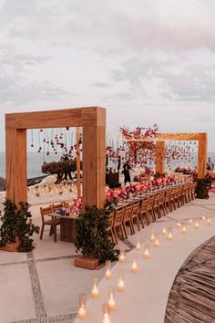 an outdoor wedding setup with candles and flowers