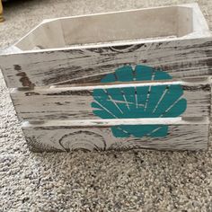 a wooden crate with a blue shell painted on it