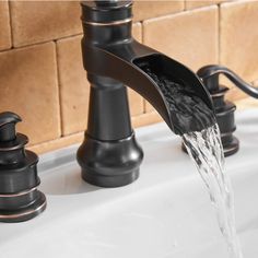 a black faucet with water running from it's sides into the sink