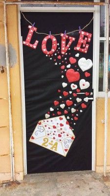 a door decorated with valentine's day decorations and love is hanging on the wall