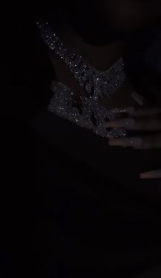 a person with their hand on her wrist in the dark