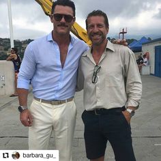 two men standing next to each other in front of a banana statue with the caption barbara gu