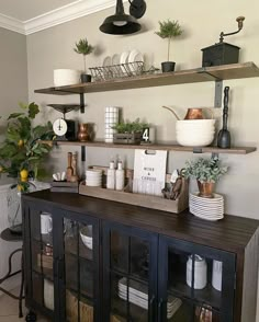 the shelves are filled with dishes and other kitchen items on top of each shelf in this room