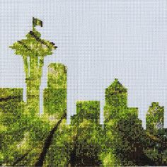 a cross - stitch picture of the seattle skyline with trees and buildings in the foreground