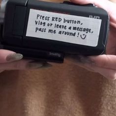 a person holding a cell phone with a message written on it's screen in their hands