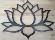 a metal lotus flower on a wooden surface