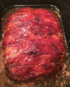 a meatloaf is cooking in a pan on the stove top, ready to be cooked