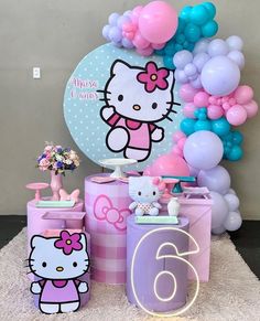 a hello kitty birthday party with balloons and decorations