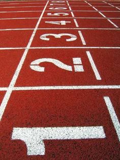 a red running track with white markings on it